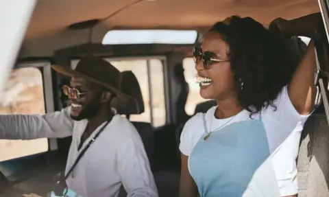Couple enjoying a scenic road trip drive in Kenya
