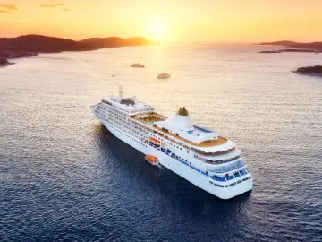 Cruise ship sailing at sunset