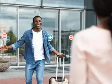Traveler greeting his partner after arriving at the airport